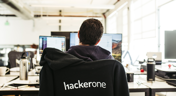 employee reading a screen sitting at desk